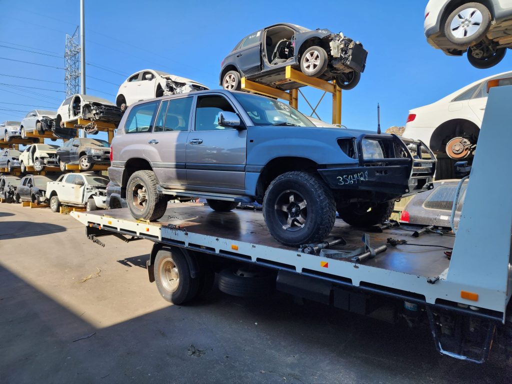 Cash for Scrap Cars Baxter VIC 1 Silver four-wheel-drive on a flatbed among vehicles at a recycling yard