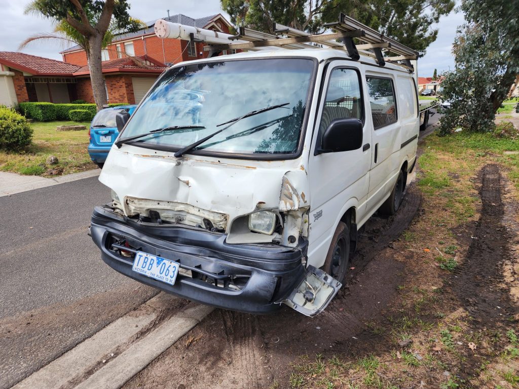 Cash for Scrap Cars Beveridge VIC 1 White van with front-end damage parked beside a residential driveway