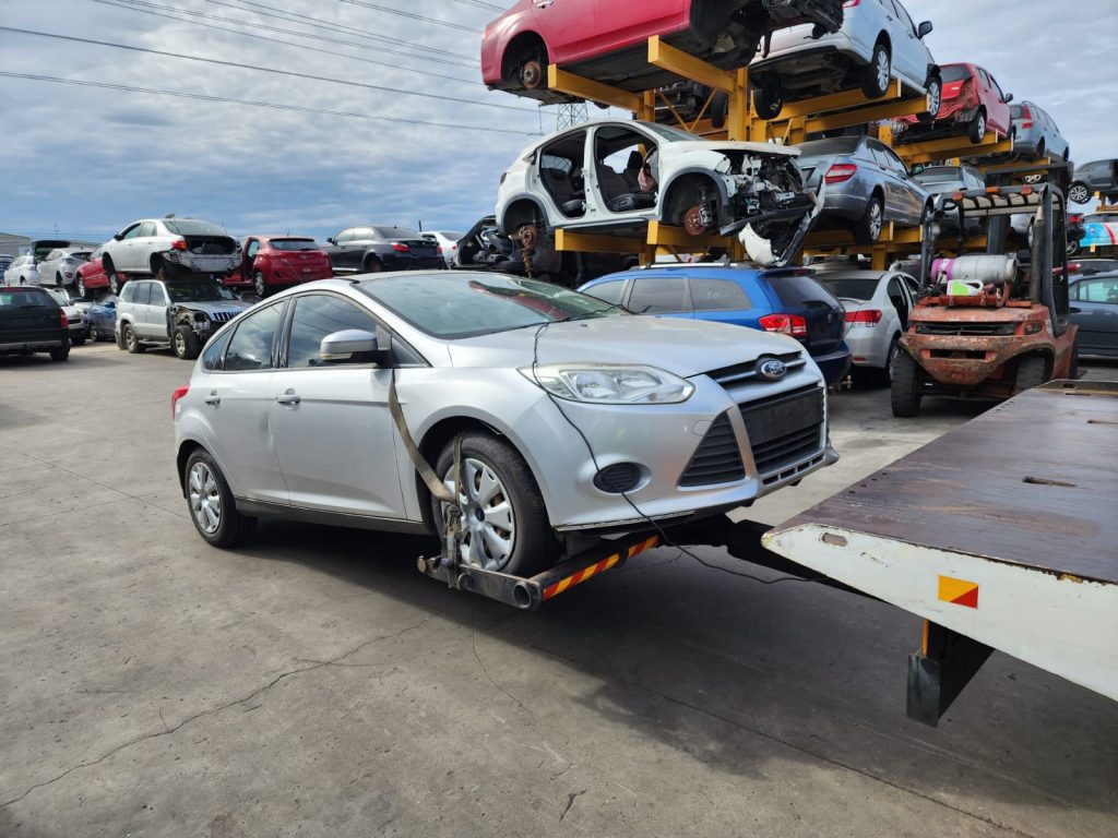Cash for Scrap Cars Ivanhoe VIC 1 Silver hatchback approaching a tow truck ramp at a vehicle yard