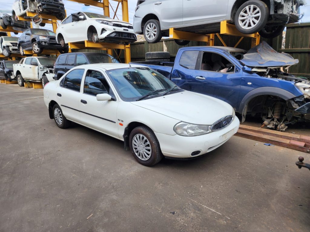 Cash for Scrap Cars Toolern Vale VIC 1 White sedan parked in a vehicle recycling yard