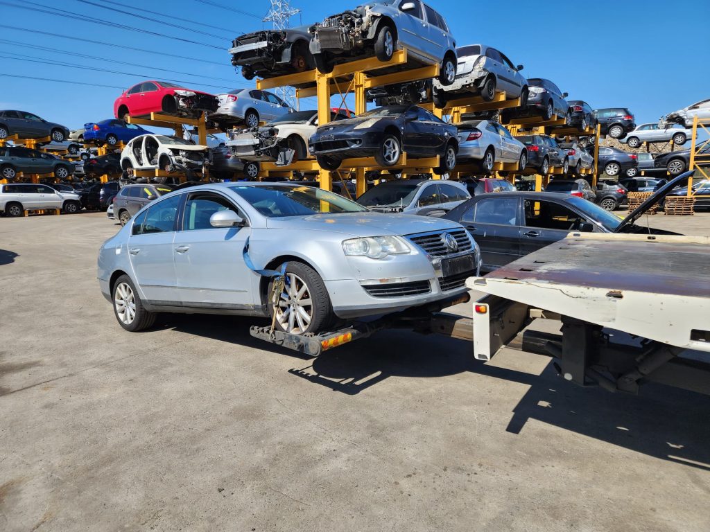 Cash for Scrap Cars Modella VIC 1 Silver sedan being loaded at a vehicle yard