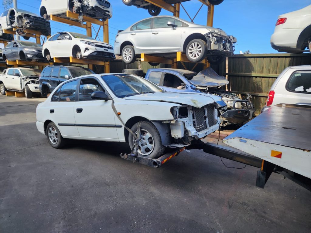 Cash for Scrap Cars Macleod VIC 1 Damaged white SUV beside a tow truck ramp