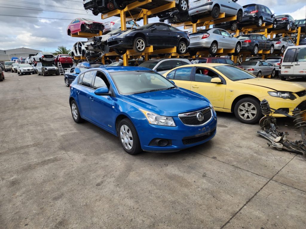 Cash for Scrap Cars Tarrawarra VIC 1 Blue sedan parked among vehicles at an automotive yard