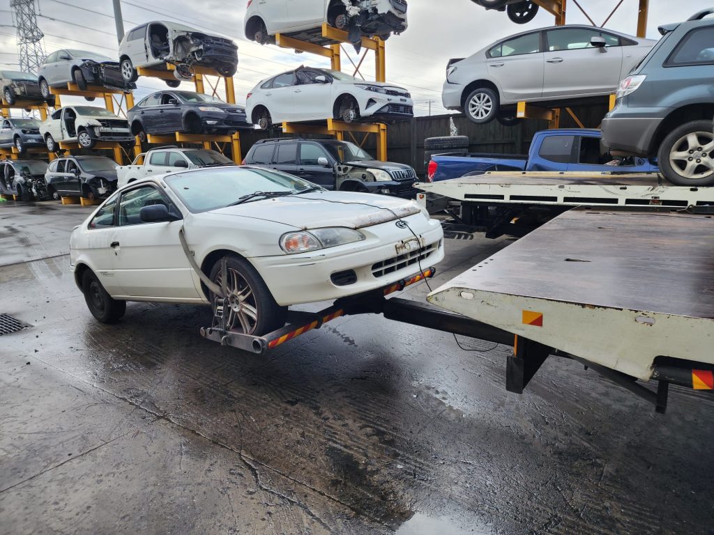 Cash for Scrap Cars Warrandyte VIC 1 White coupe positioned beside a tow truck ramp