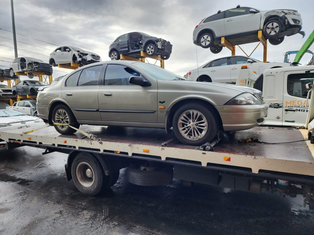 Cash for Scrap Cars Strathmore VIC 1 Silver sedan on a white flatbed at a recycling yard