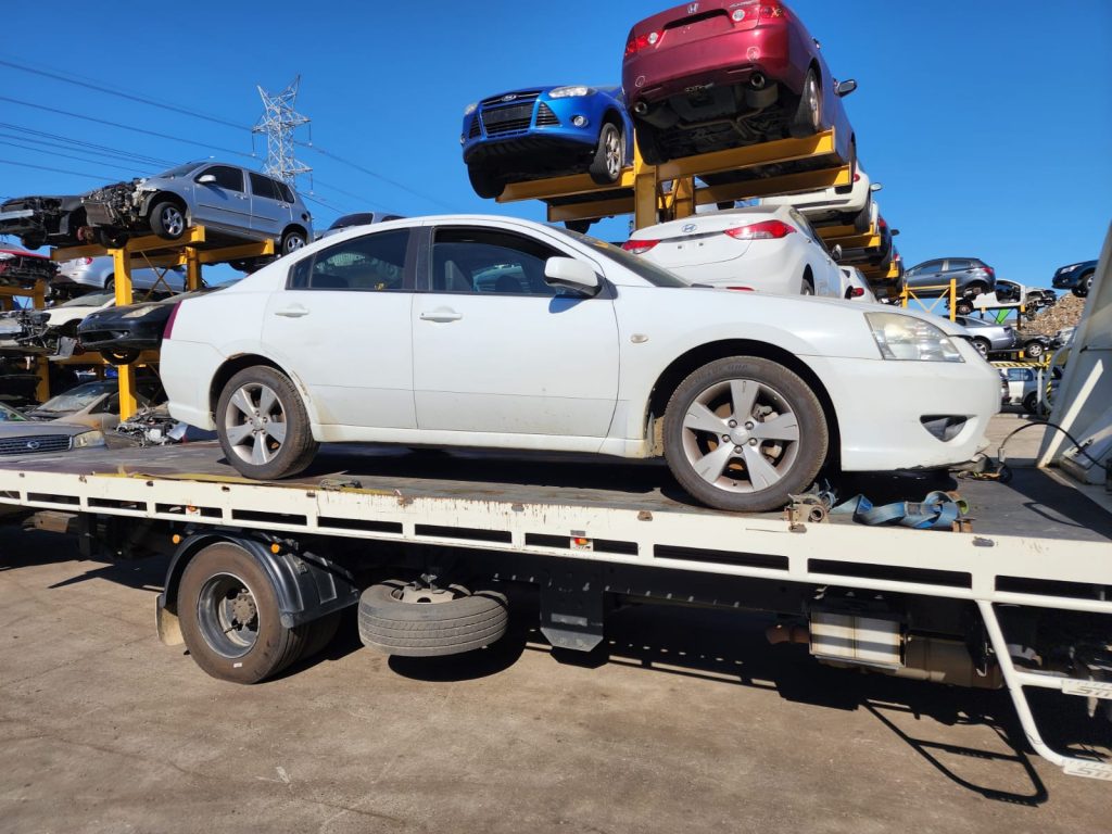 Cash for Scrap Cars Coburg VIC 1 White sedan secured to a white tow truck