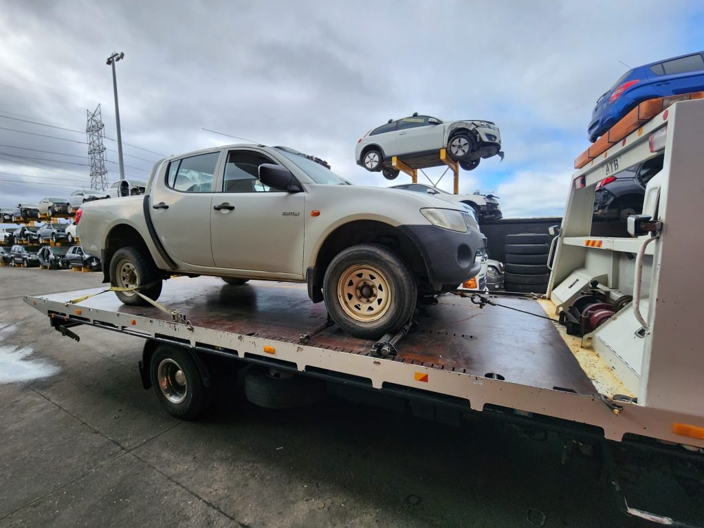 Cash for Scrap Cars Yarrambat VIC 1 Silver dual-cab ute on a flatbed tow truck