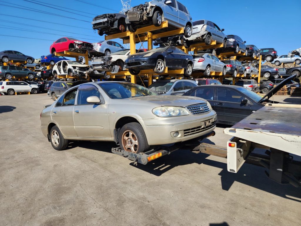 Cash for Scrap Cars Coldstream VIC 1 Gold sedan next to a flatbed loading ramp
