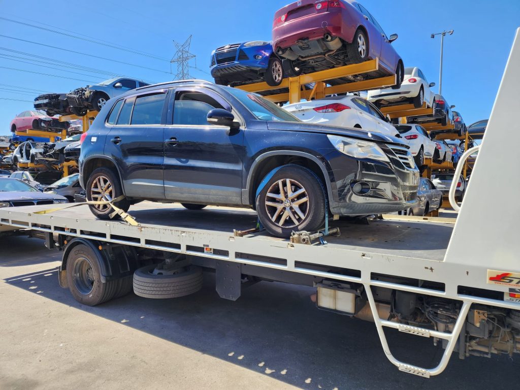Cash for Scrap Cars Devon Meadows VIC 1 Blue SUV secured to a tow truck at a recycling yard