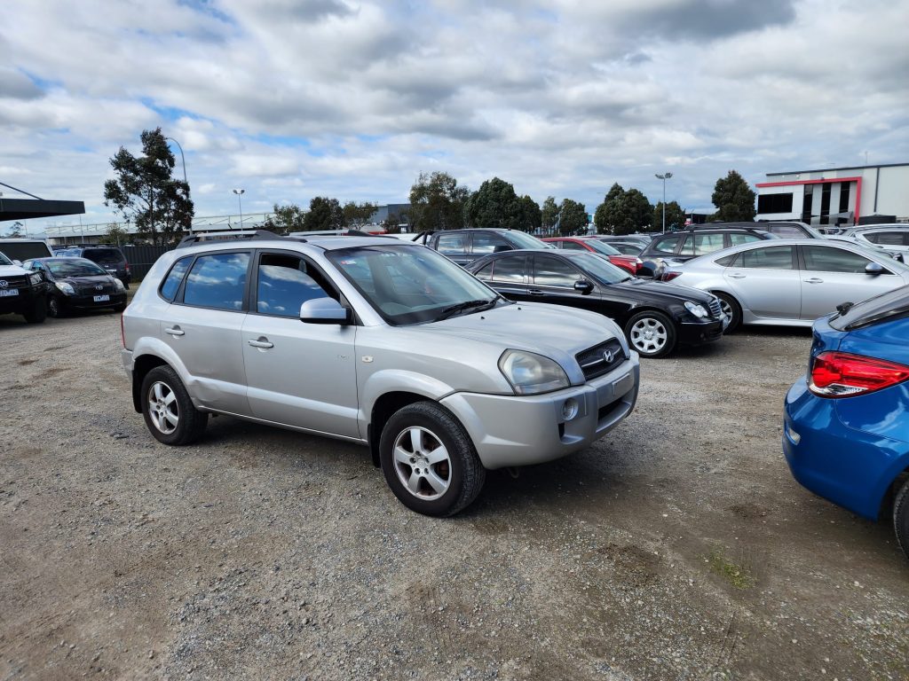 Cash for Scrap Cars Hampton Park VIC 1 Silver SUV parked among cars at a vehicle yard